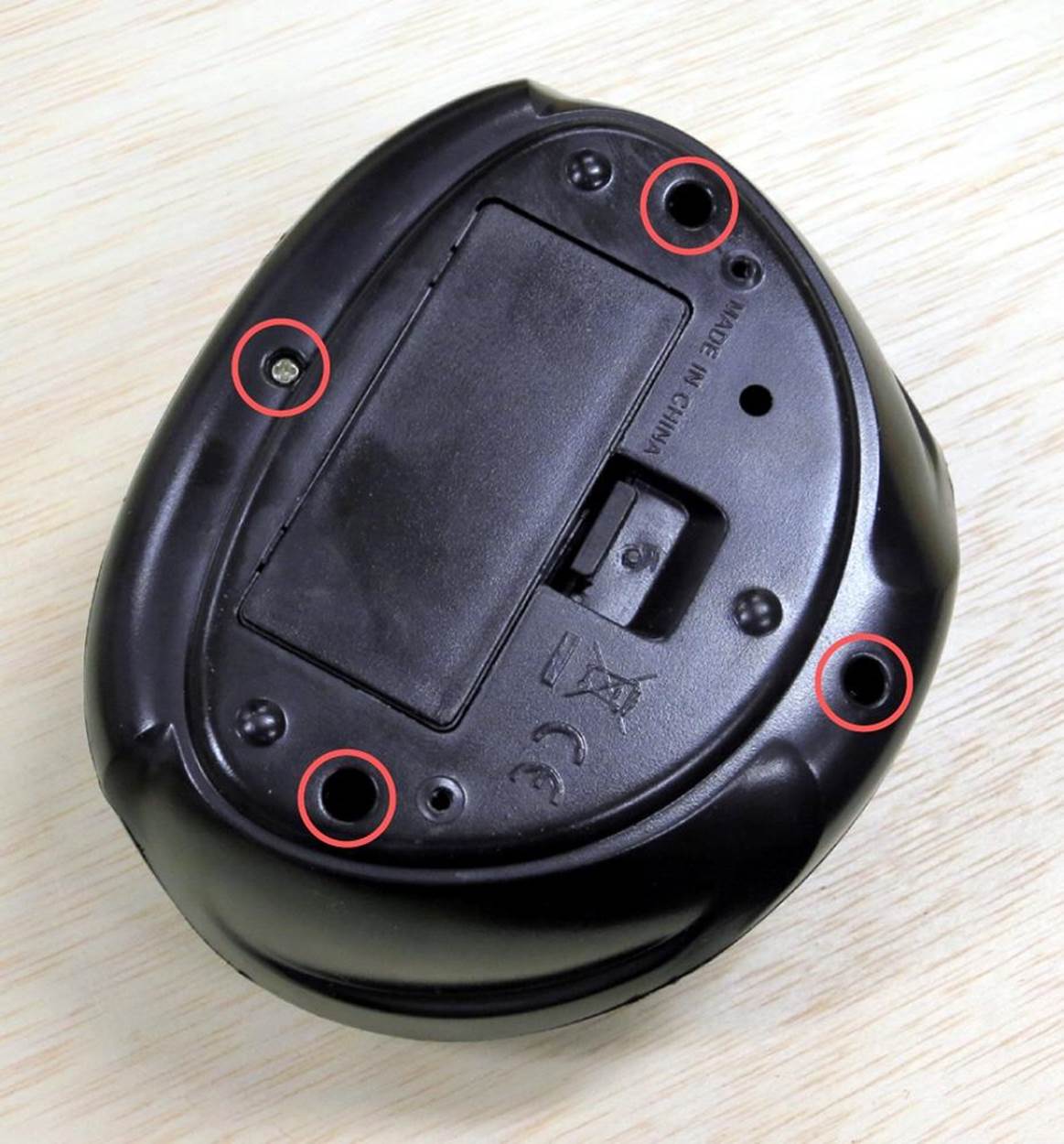 All four screws (circled) must be removed to open this clock.