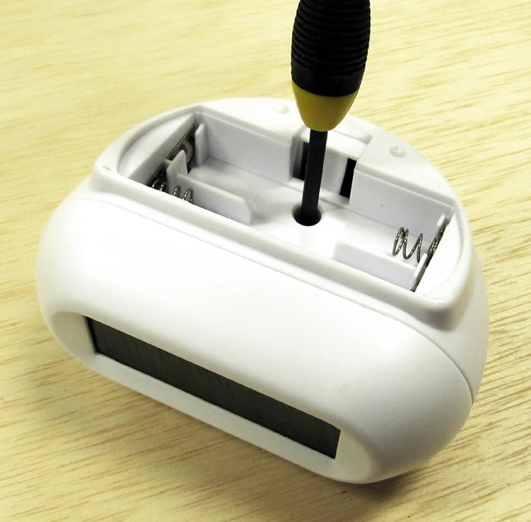 Only one screw secures the case of this clock, but it is hidden inside the battery compartment.